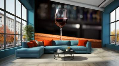 Glass of red wine on bar Wall mural