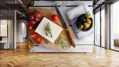 Greek feta cheese on a black plate. Greek authentic feta cheese with olives on the side. Wall mural