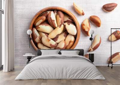 Brazil nuts in a wooden bowl on linen fabric. Dried seeds of Bertholletia excelsa without shells. Brazil nuts, notable for diverse content of micronutrients, especially a high amount of selenium. Wall mural