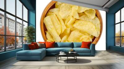 Salted potato chips with peel, also crisps, in wooden bowl. Thin slices of potato, deep fried in oil until crunchy. Served as snack, side dish or appetizer. Close-up from above over white, food photo. Wall mural