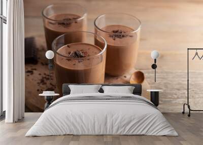 Homemade chocolate mousse made of dark chocolate,eggs, fresh cream and sugar on a wooden table. Top view. Wall mural