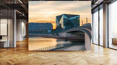 beautiful panoramic view at sunset, Berlin Spreebogen at Hugo-Preuss Bridge with a view of the Cube Berlin and John F. Kennedy House building at the main train station and the river Spree Wall mural