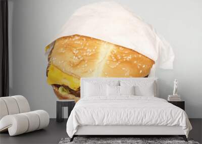 A fast food cheeseburger on a table. Wall mural