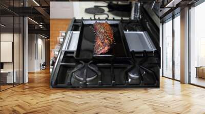 Marinated St. Louis cut pork ribs baked on a carbon steel tray, resting on the stove top in a home kitchen. Wall mural