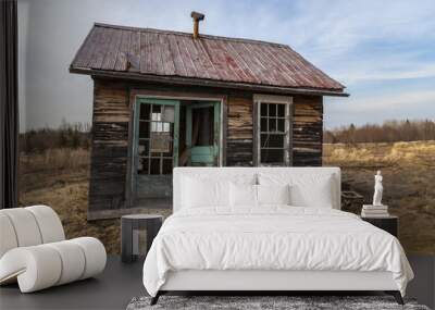 neglected cabin in a farmer field Wall mural