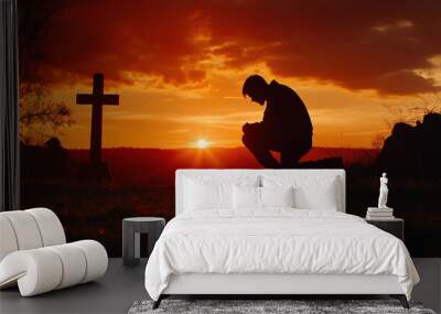 Silhouette of a Man Kneeling in Front of a Cross at Sunset with Copy Space for Easter or Christian Theme Background, Photorealistic Wall mural