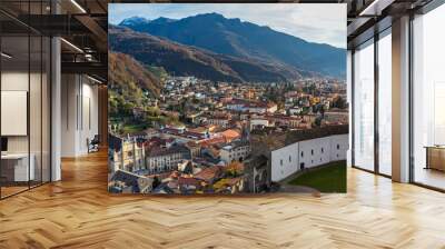 Stunning aerial panorama view of Bellinzona old town in beautiful sunlight from top of Castelgrande Castle with Swiss Alps and blue sky cloud in background, on sunny autumn day, Ticino, Switzerland Wall mural