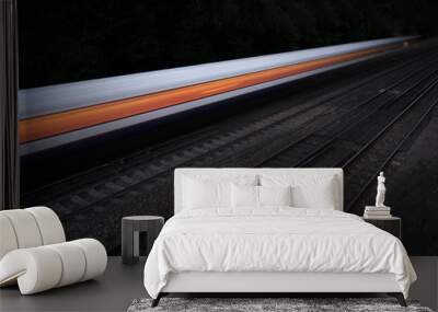 Speeding fast train on an isolated black background Wall mural