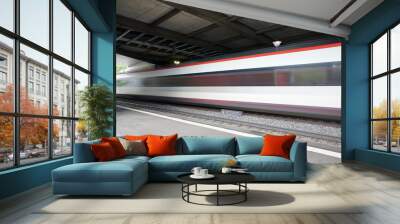 Train speeding through a swiss station captured as a motion blur Wall mural