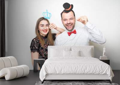 young couple friends pose photo booth funny props Wall mural