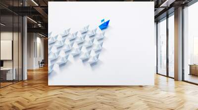 Arrow shaped group of paper boats with blue leader going in same direction - 3D illustration Wall mural