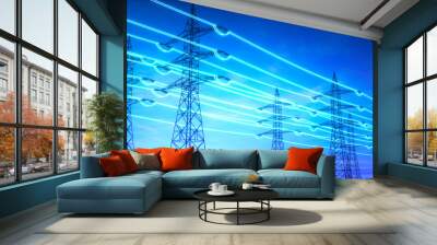 Electricity transmission towers with glowing wires against blue sky - Energy concept Wall mural