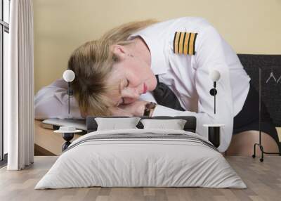 Tired female airline pilot wearing insignia of a captain Wall mural