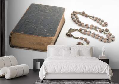 Wide studio shot of very old, vintage Holy Bible with lots of ornaments on the cover and yellow pages and old rosary isolated on white background. Christianity concept. Time of prayer. Wall mural