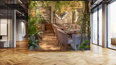 Wooden modern restaurant empty area with picnic wooden tables chairs bench with green plants. Wall mural