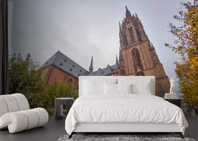 Scenic view of Frankfurt Cathedral (Frankfurter Dom) - Roman Catholic Gothic church located in centre of Frankfurt am Main in Germany. Beautiful cloudy summer look of christian temple in german city Wall mural