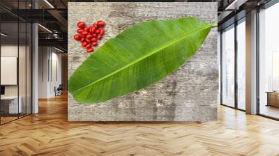 cherry tomatoes on wooden table with banana leaf Wall mural