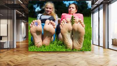 Family lying on the grass Wall mural