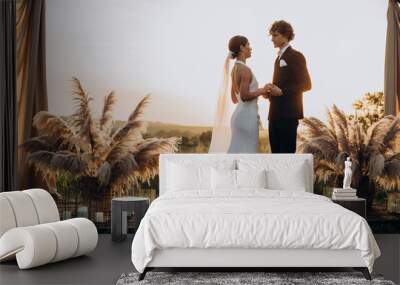 Bride and groom on their wedding ceremony Wall mural