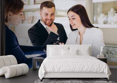 Couple at jewelry shop paying with card Wall mural