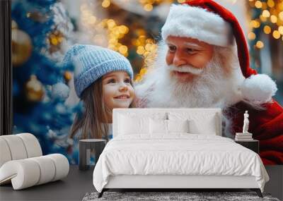 Happy little girl receiving christmas present from santa claus Wall mural