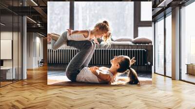 Mother and daughter yoga at home Wall mural