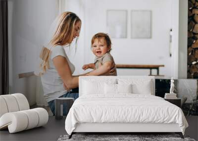 Mother with her little son playing at home Wall mural