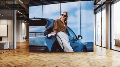 Woman charging electric car Wall mural