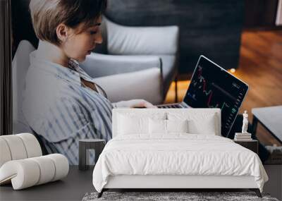 Woman working on exchange and watching rise and fall of graphics Wall mural