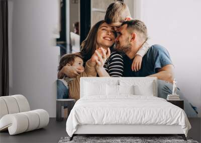 Young family with their sons at home having fun Wall mural