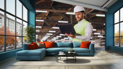 Young man engineer working on factory Wall mural