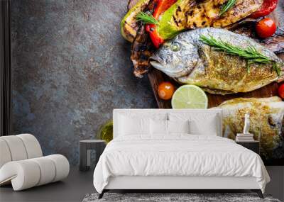 Baked Dorado fish, sea bream with grilled vegetables, herbs and seasonings, top view Wall mural