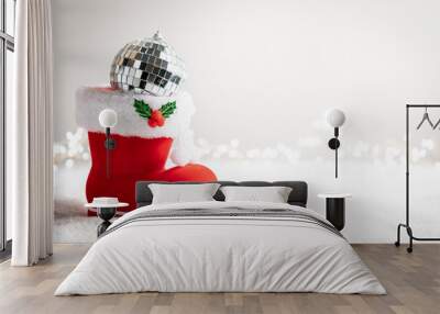 Christmas creative composition made with Santa boots with sweets and gifts on snow background. Minimal New Year shopping season concept. Winter holidays idea. Wall mural