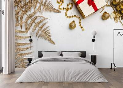 Christmas holidays composition with gold decorations on white background with copy space for your text Wall mural