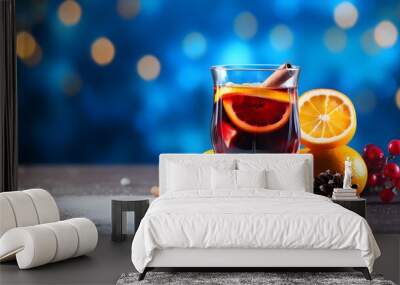 Christmas mulled red wine with spices and fruits on a blue background. Traditional hot drink at Christmas time Wall mural