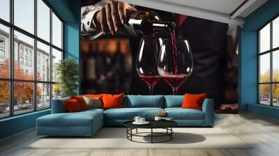 Close up male sommelier pouring and tasting a flavor and checking red wine quality poured in transparent glass in a wine cellar or restaurant Wall mural