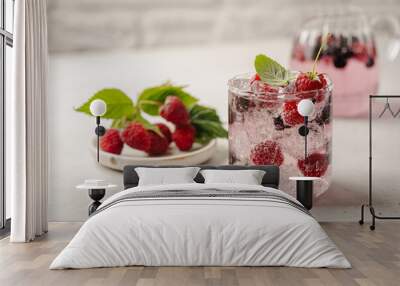 Glass of berry cocktail or drink soda with fresh berries on white background Wall mural