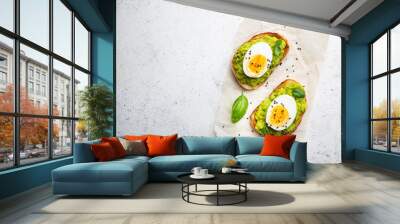 Healthy breakfast, toast with avocado and egg, top view, copy space. Vegetarian food concept Wall mural