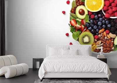 Healthy fresh fruit salad bowl on white background. Top view. Healthy food concept, healthy high vitamin fruit, mixed fruit and nuts background. Wall mural