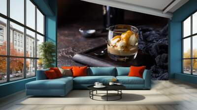 Ice cream with caramel topping and Irish cream liqueur in a glass over dark background. Wall mural