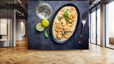 Shrimps in cream sauce with Coconut milk on a plate over black background, top view or view from above, flat lay Wall mural