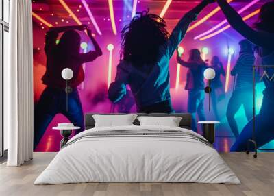 Silhouette image of people in ultraviolet light dance in disco night club to music from DJ on stage . New year night party and nightlife concept . Wall mural