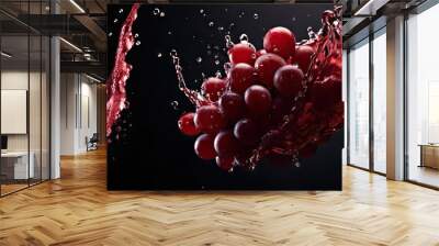 Splashing red wine with red grape close up on dark background Wall mural