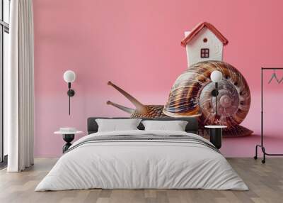 The snail with a house on a shell on its back on pink background. Easy housing metaphor. Real estate business concept. Wall mural