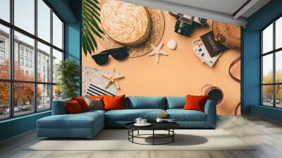 Top view travel concept with retro camera films, map and passport on light orange background with copy space. Flat lay tourist essentials Wall mural