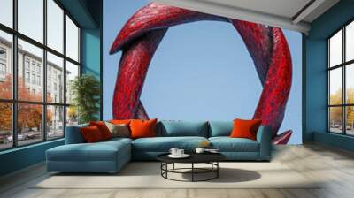 striking red sculpture featuring swirling, curved shapes in circular design, symbolizing harmony and balance. This artistic piece adds bold touch to any space Wall mural