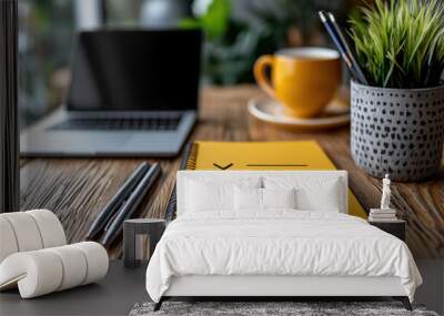 vibrant yellow notebook with to do list sits on wooden desk, accompanied by laptop, cup of coffee, and potted plant, creating inviting workspace atmosphere Wall mural