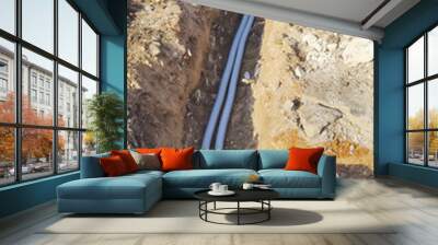 Corrugated pipes underground to connect two inspection wells Wall mural