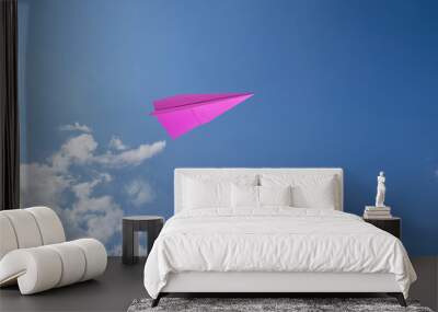 pink paper rocket with blue sky background. Wall mural