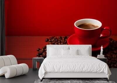 Red coffee cup placed on a red background and decorated with coffee beans. Wall mural